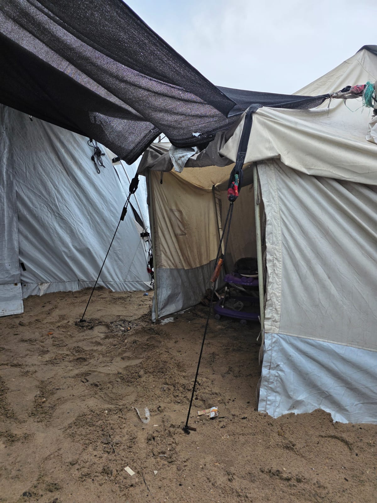Fabric roofs and ropes between closely spaced tents at Al Anwar